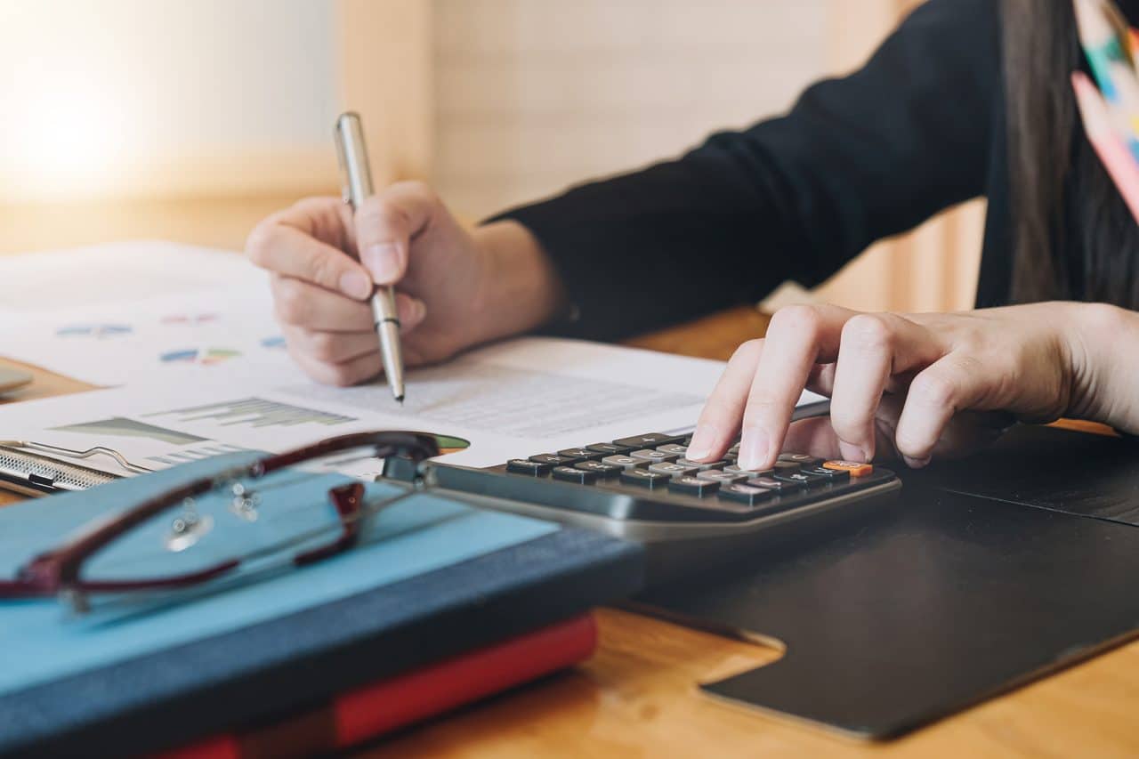 accountant working with calculator for Fraud investigation | Lone Rock investigation